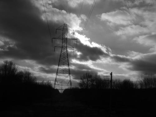 Heavy Clouds - This is a photograph for which was taken by Bernie Thomas in the medium of black and white that shows heavy silouetted clouds in the back ground. 