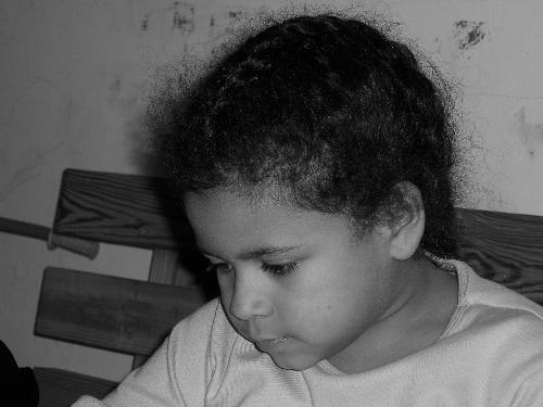 Concentration - This is a photo I took of my granddaughter while she was concentrating on her homework. I was trying out my new digital camera and all the functions it had and this was my first black and white photo.
