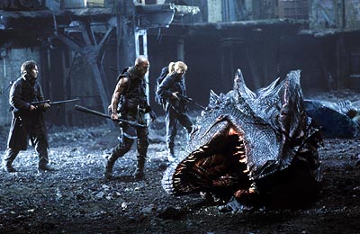 Reign of Fire  - Christian Bale, Matthew McCanoughey, and Izabella Scorupco stand over the corpse of a dragon they just killed.