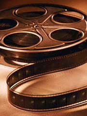 movies - movie reel in golden brown