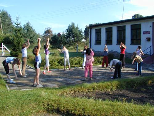 kids exercising - exercising in small group outdoors