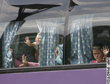 Children wave from inside the bus, innocently play - in which they are being held hostage by their daycare center owner in Manila.