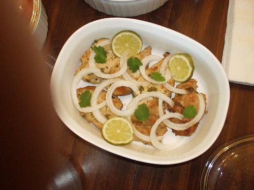chicken - chicken fry garnished with lemon wedges and onion rings