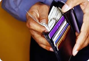 How easily do you part with your money? - A picture of a guy out of cash. He is showing his wallet and implying how broke he is.