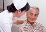 A nurse and her patient - A nurse is talking with her patient. A nurse and her patient - A nurse is talking with her patient.