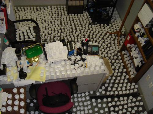 Office prank - Good clean fun. Ingredients: 1 office cubical 2000 paper cups several gallons of water Directions: Fill cups half full of water. Place on every available flat surface at one inch intervels. Take lots of pictures. Enjoy co-worker reaction.