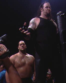The Undertaker..... - The Undertaker making an entrance into the ring with his one time tag team partner..the Big Show. Together they formed a formidable team....which dominated the WWE as long as they were together.......