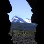3 Sisters Mountains - Three Sisters Mountains, part of the Cascade Range, as seen through a crevace on the side of a mountain. The Three Sisters is located in Central Oregon, just outside of Sisters, Oregon.