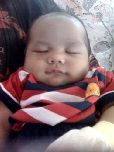 sleeping - sleeping on his aunt grandma hip !