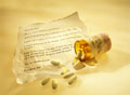 Pills & Goodbye note - Picture of some pills on top of a goodbye note left by someone suffering from depression.