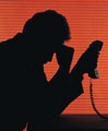 Sad Businessman - Picture of a shadowy sad businessman holding his head.