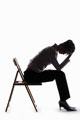 Sad Person - Picture in silhouette form of a person holding their head in their hands.