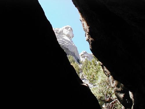 A narrow view of Mount Rushmore - This is a narrow view of Mount Rushmore in a photo taken through a crevice near the base of the mountain.