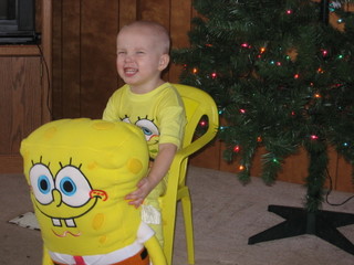 SpongeBob SquarePants Fanatic - My son, Christmas 2006, new SpongeBob stuffed toy, pajamas, chair, in front of the Christmas tree.
