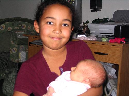 My daughter Serenity and my daughter Arionna - This is a picture of my oldest daughter Serenity holding my youngest daughter Arionna.