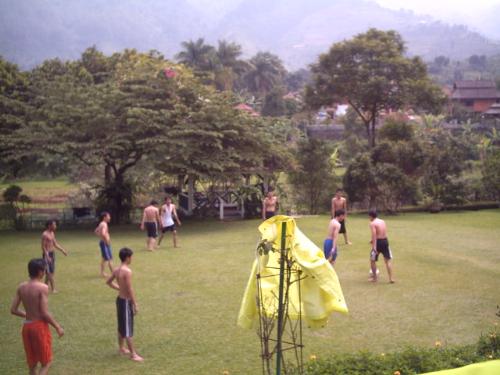 playing soccer - playing soccer on side yard of village