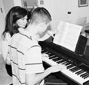 A Teacher teaching piano - A teacher teaching piano, black and white photo