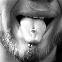 Tongue ring - Man sticking out his tongue with a ring in it.