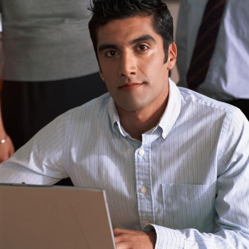 Working on his Mac - Typing away.