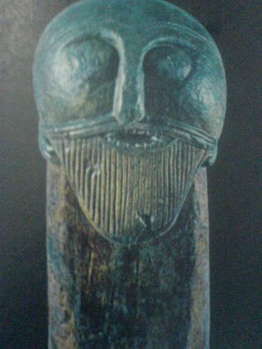 Bearded Seafarer - A bearded seafarer with menacing teeth, carved in oak, decorates a cart found at Oseberg.