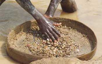 Panning for Blood diamond - a miner or slave panning the rivers for diamonds they will not be allowed to keep