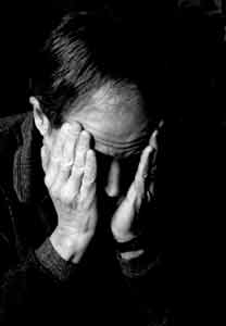 head in hands - man feeling depressed with head in his hand