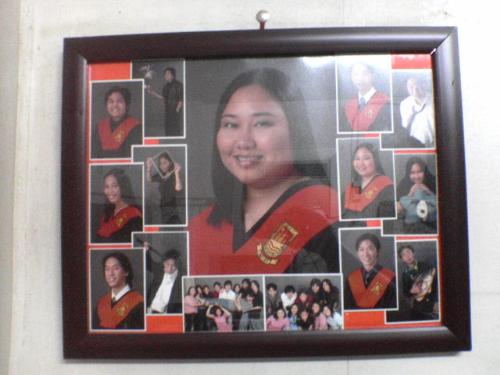 My graduation frame on my wall. - This is a shot of me and my friend&#039;s graduation pictures which I arranged into a frame and hung on my wall.