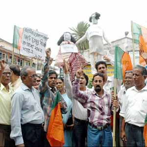 political protest - Alleging conspiracy by the Congress and Left Front against BJP president Rajnath Singh, members of the party staging a protest in Agartala, India.