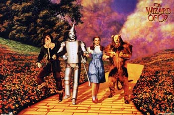 Cast - image of all going down the yellow brick road, Dorothy, Tinman, Cowardly Lion, Scarecrow and Toto