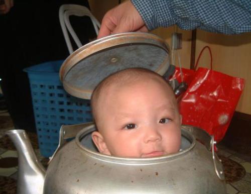 baby in a kettle - baby inside a big kettle