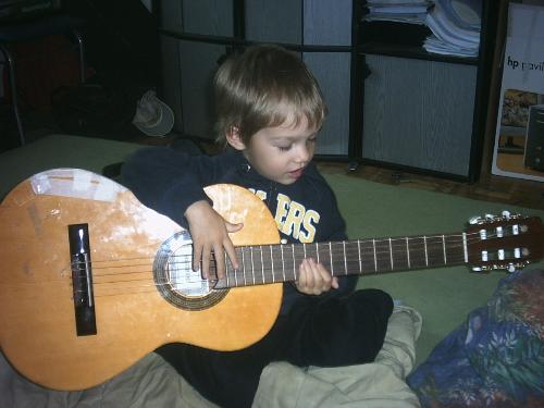 justin  - our son try to play guitarr