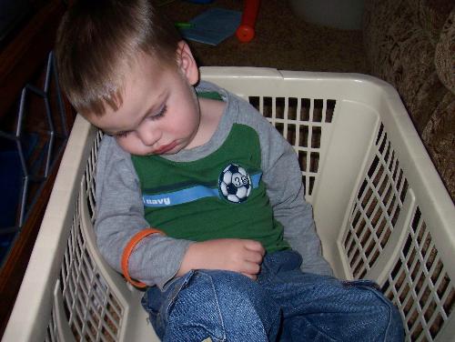 Sleeping Places - How comfortable can it be to fall asleep in a laundry basket? I don't know what this kid does to wear himself out like that but, this is one of those days. I suppose he was playing and singing something like. 'Row row row your boat, gently down the ssszzzzzzz....'. Kids!