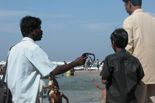 Hawkers - Hawker selling sunglasses in the beach of India.