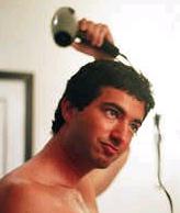 Blow drying. - Guy blor drying his hair.