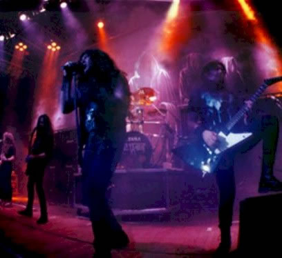 Testament - The Band performing live on stage.