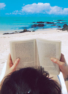 a girl reading a book - a girl reading a book at the beach