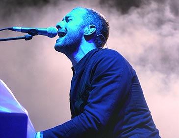 Chris Martin on Piano - As passionate as could be, chris is jamming on the piano. He always plays hunched over, which I find amusing.