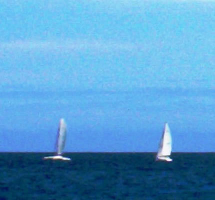 Ships Passing - Two sailboats passing on the open oceans.
