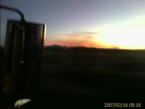 Desert Sunset - This photo was taken while my husband and I were in Arizona. You can see the mirror of our Kenworth in the photo as well. I took this one with my cell phone, and we were moving, so the quality is not as good as I would like. Enjoy!