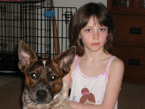 my daughter - This is a photo of my youngest with her 10 month old puppy. Looks like the dog is going to end up being bigger than her.