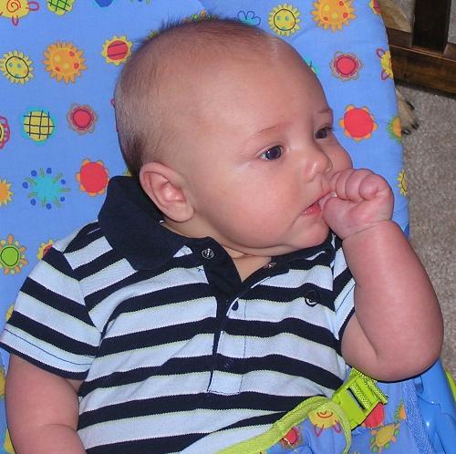 Son sucking his thumb - He just learned how to get his thumb, before it was his whole fist. 