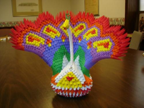 Modular Origami Peacock - This peacock took 40 hours to fold the 1300+ pieces and construct. For some time I had said I wanted to attempt the peacock but never got around to it. Finally last November my pastor challenged me to do it so here is the result. The finished peacock stands around 13 inches tall.  BTW did I mention I am legally blind?