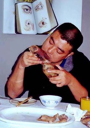 A man eating... A baby??????????? - For more info..check www.trosch.org/lif/cannibalism.html A man eating... A baby??????????? - For more info..check www.trosch.org/lif/cannibalism.html