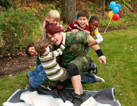 John Cena - This is a pic. of John Cena who is playing with kids on their party. The photo shows that even after getting rich and famous he is still down to the earth and remains kind and lovable with everybody.The photo also shows that children who are so innocent also demands love, affection and care