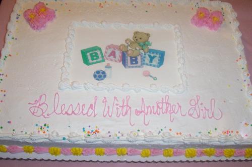 Baby Shower  - This is a baby shower cake... You can't tell but an hour before the shower it was to be picked up, and when I got there the inscription was wrong and they had to scrape it off and re-do it. This is a white cake with Whipped Cream frosting, bought from a grocery store.