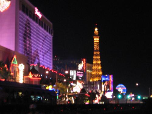 The Eiffle Tower - The Eiffle Tower glows in the background in this shot during the nightime in Vegas. The lights are so brilliant at night. This photo was taken December 2006.