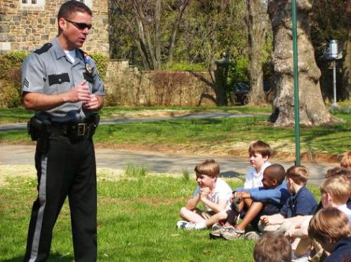 stranger danger - A cop teaching children about the importance of 'stranger danger.'