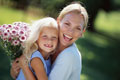 Mom and daughter with flowers - Mom spends time with daughter in a garden...