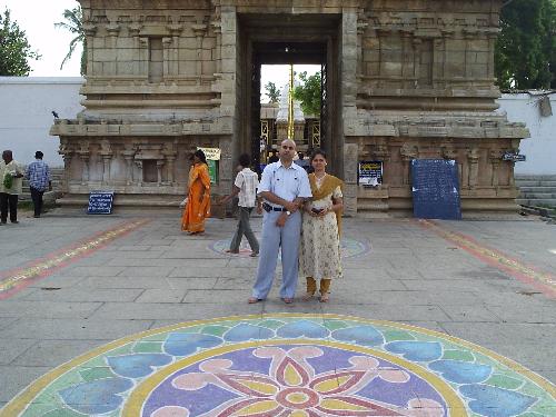 Me and my Wife - This was the snap taken on our first visit to the Temple -Shrine, Tirupati. You can see the Mangauram temple in the background.