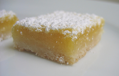 Lemon Bar - Sweet lemon bar with powdered sugar on top and pie crust on the bottom.